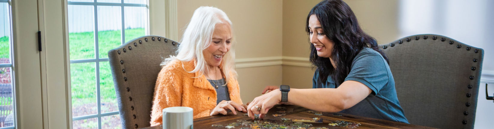 caregiver helping woman out of bed
