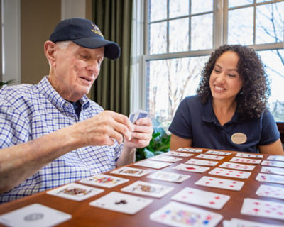 Caregiver playing game with resident