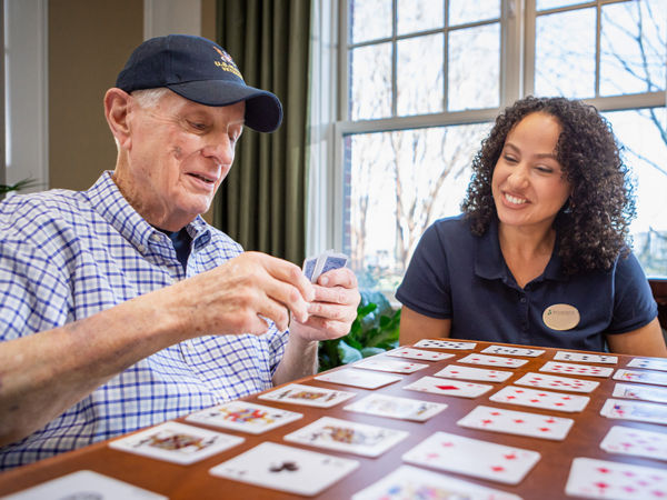 Caregiver playing game with resident