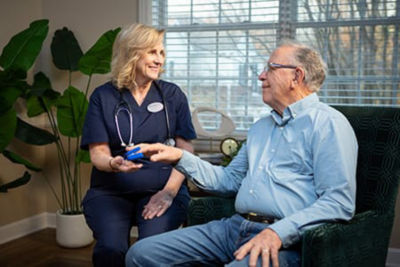 nurse taking residents heart rate