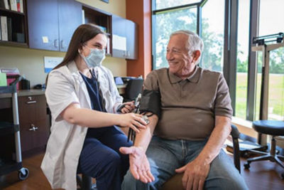 nurse taking residents blood pressure