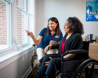 Associate and woman looking out the window
