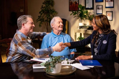 Sales associate shaking hands with family